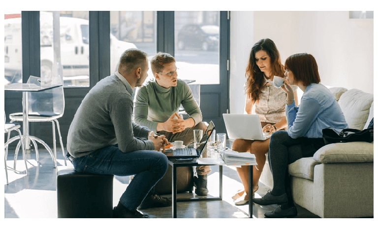 people sat around a table talking