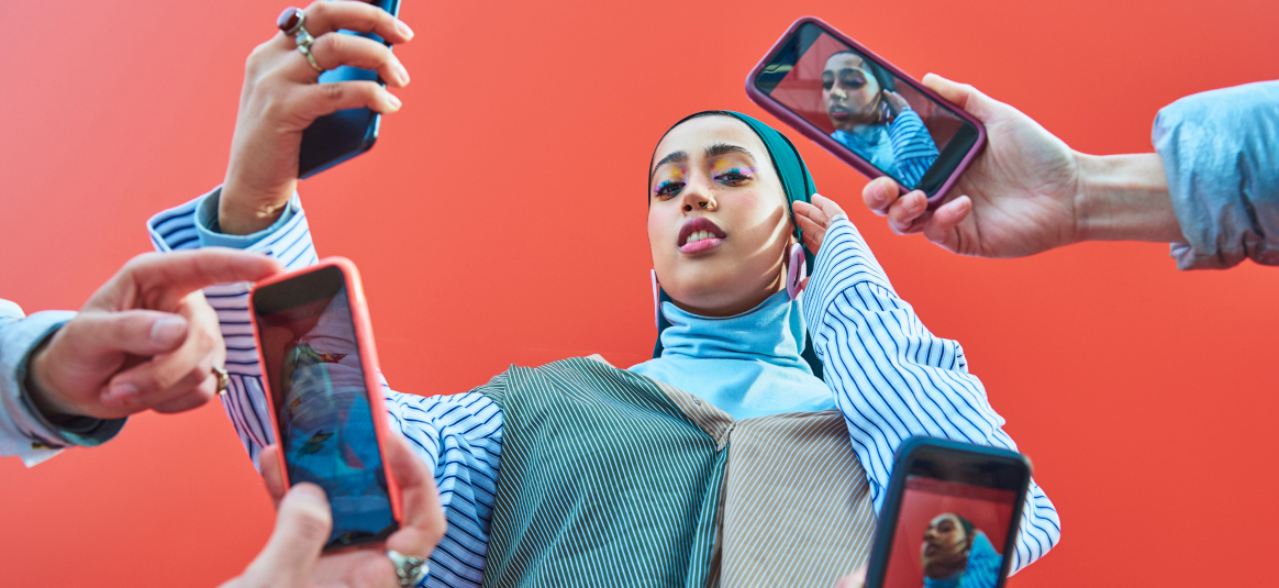 Photo of a woman surrounded by four mobile phones