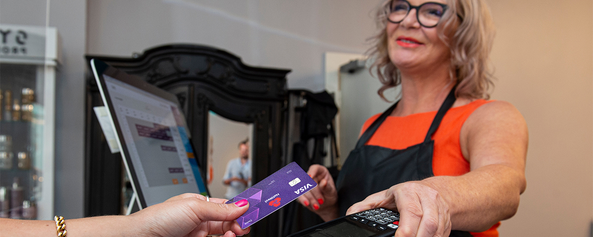 Shop owner taking a contactless payment