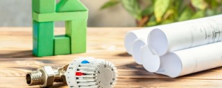 Photo of cardboard tubes and a green model house