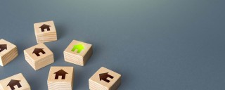 Photo of several wooden blocks with the home symbol