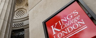 Photo of a red King’s College London plaque on the side of a building