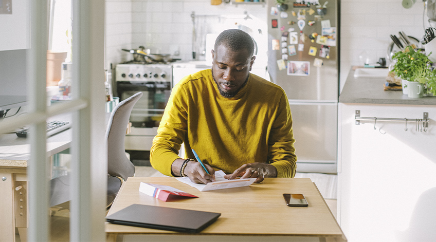 Man working at kitchen table