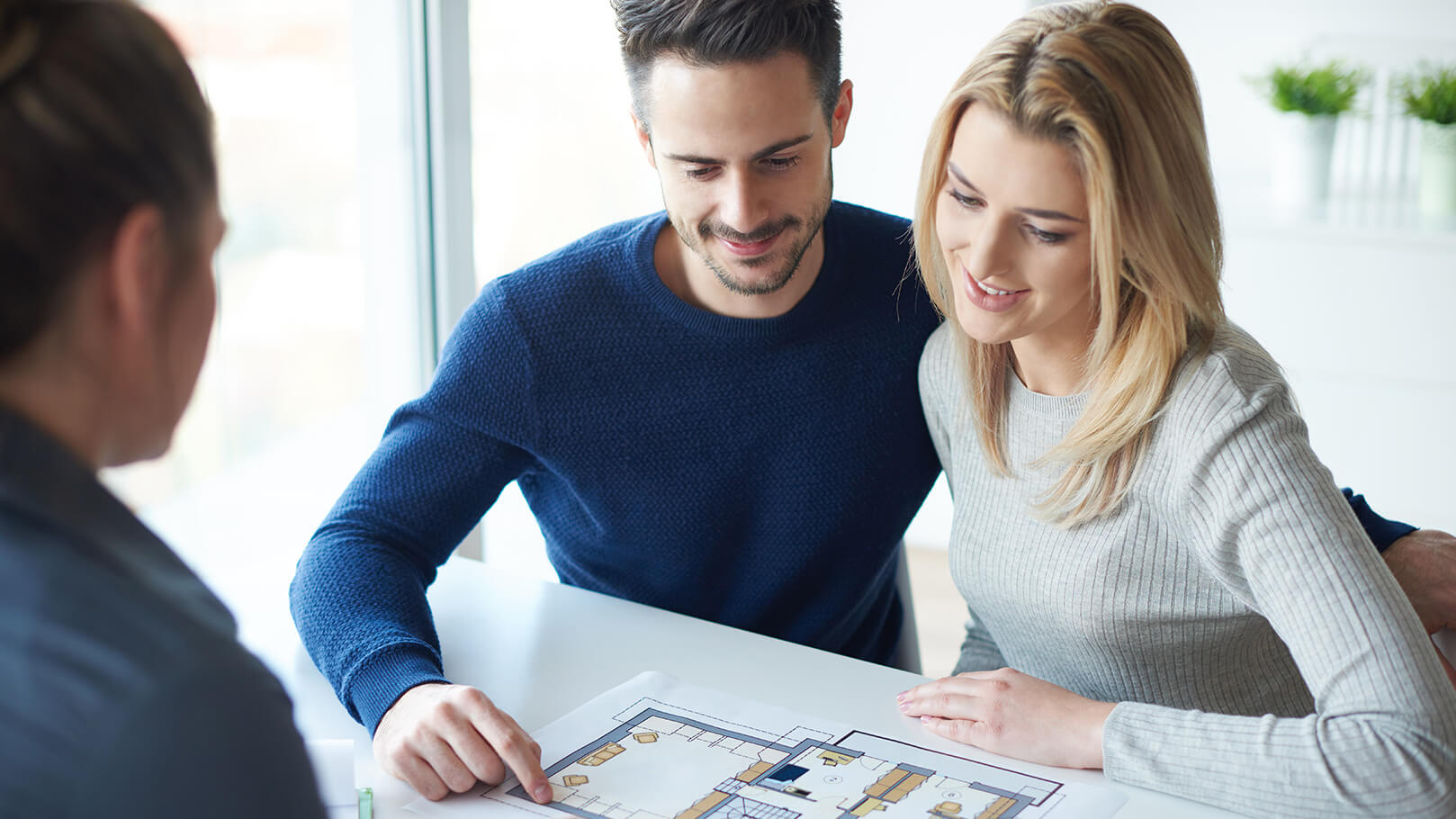 Young couple look over a diagram received from a house survey